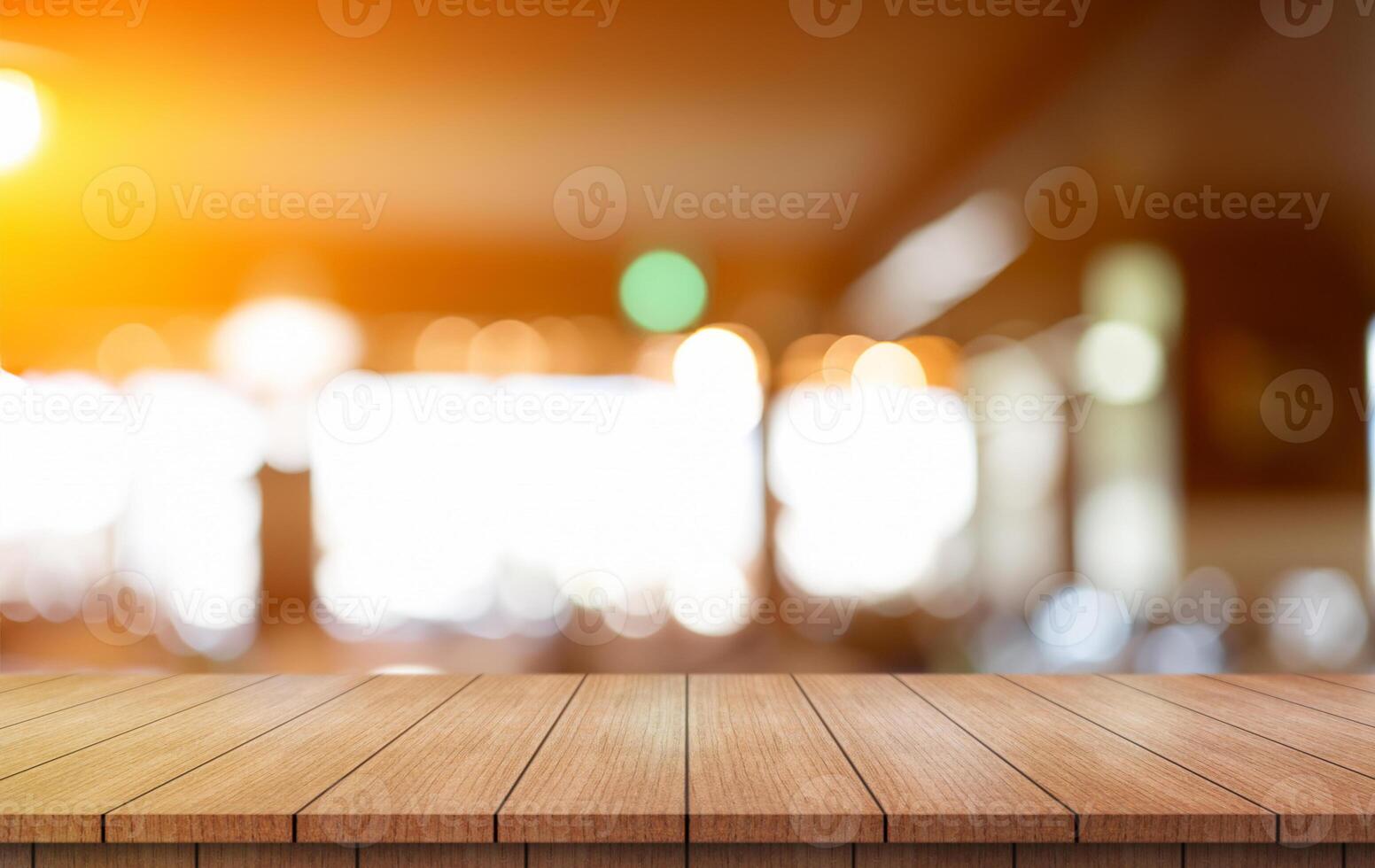 Empty wooden table top with lights bokeh on blur restaurant background. photo