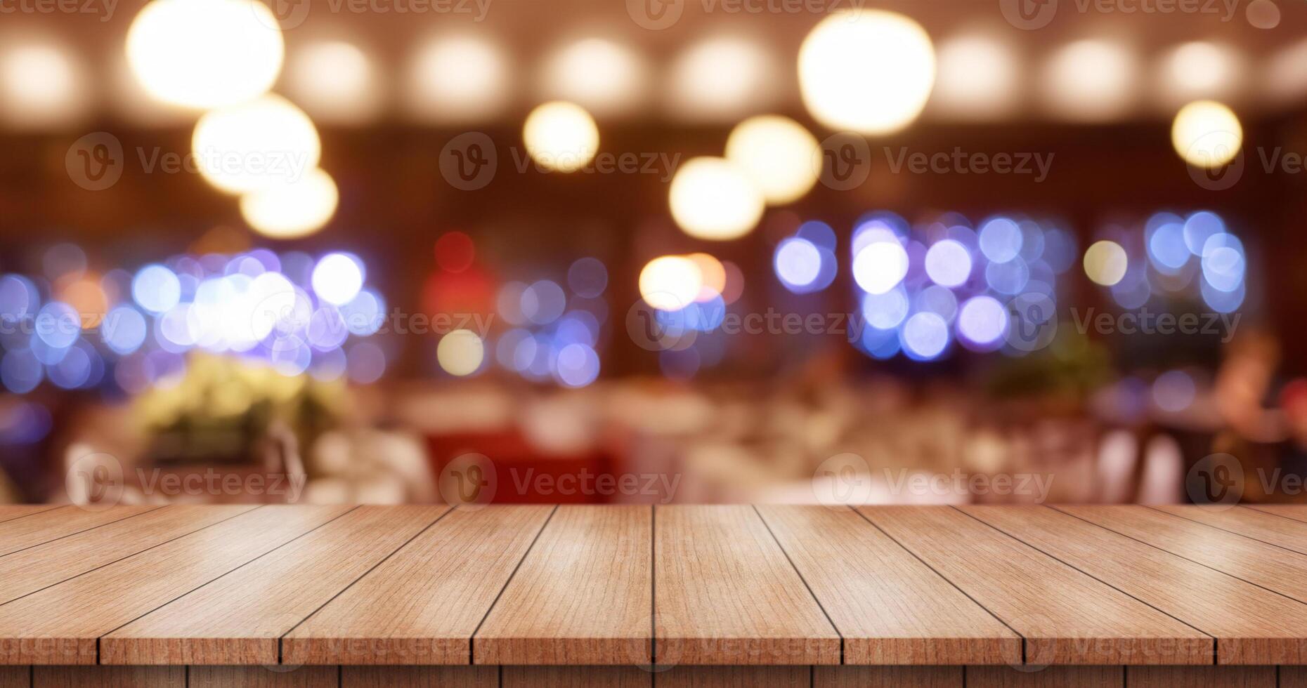 Empty wooden table top with lights bokeh on blur restaurant background. photo