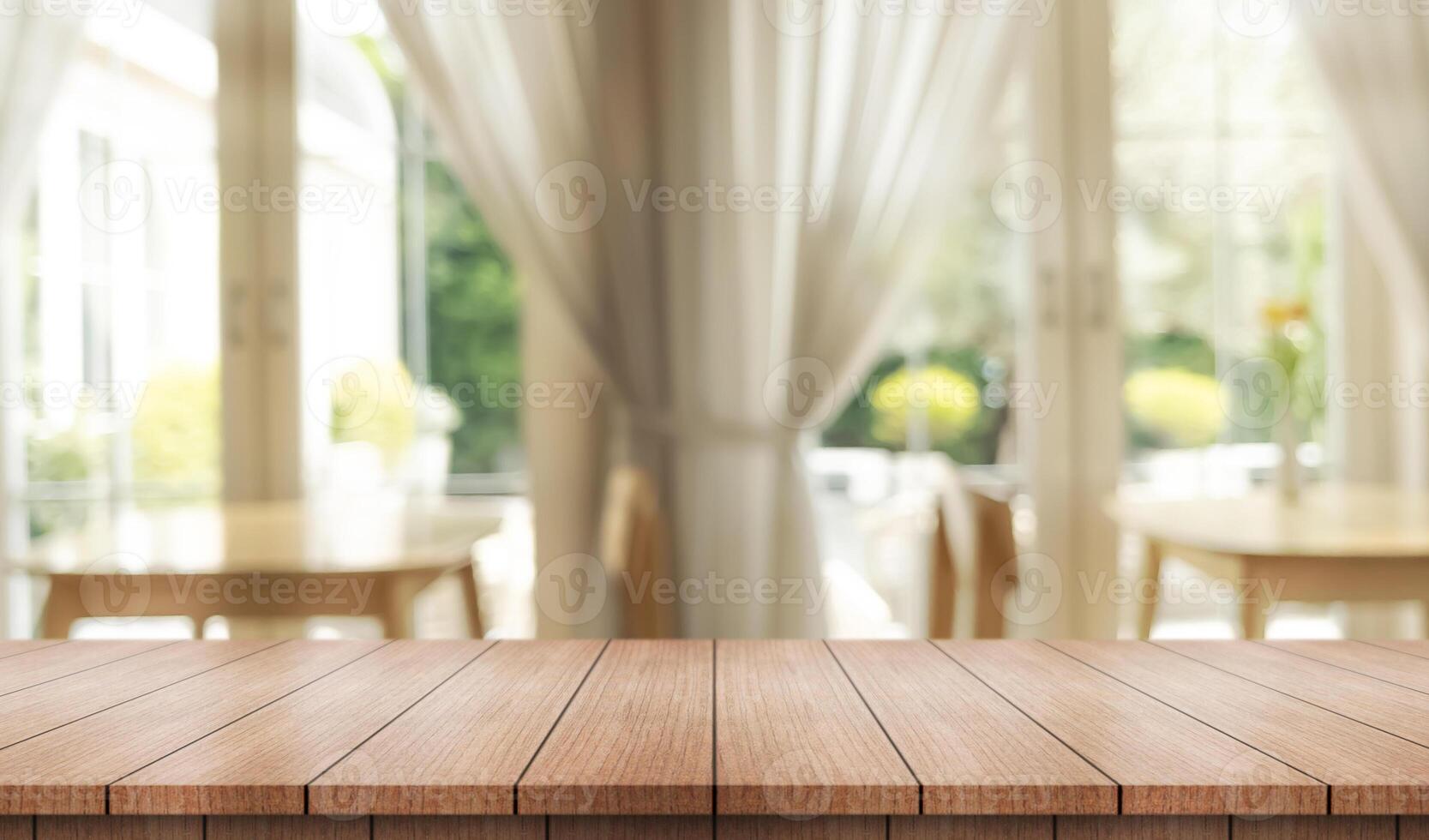 Empty wooden table top with lights bokeh on blur restaurant background. photo