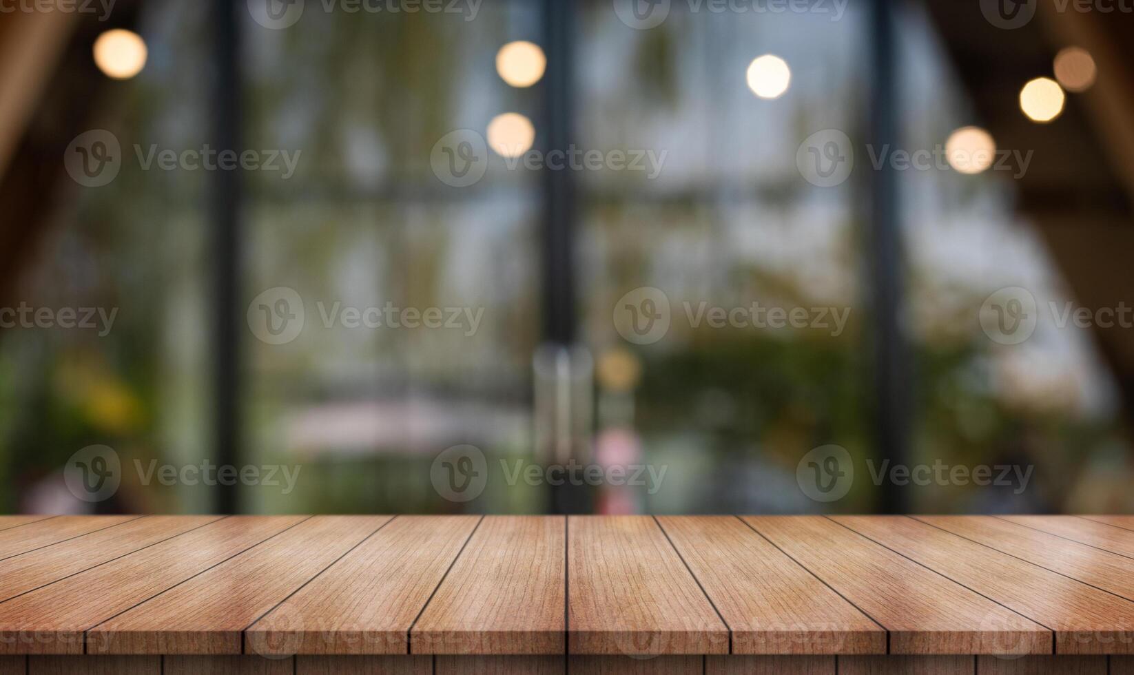 Empty wooden table top with lights bokeh on blur restaurant background. photo