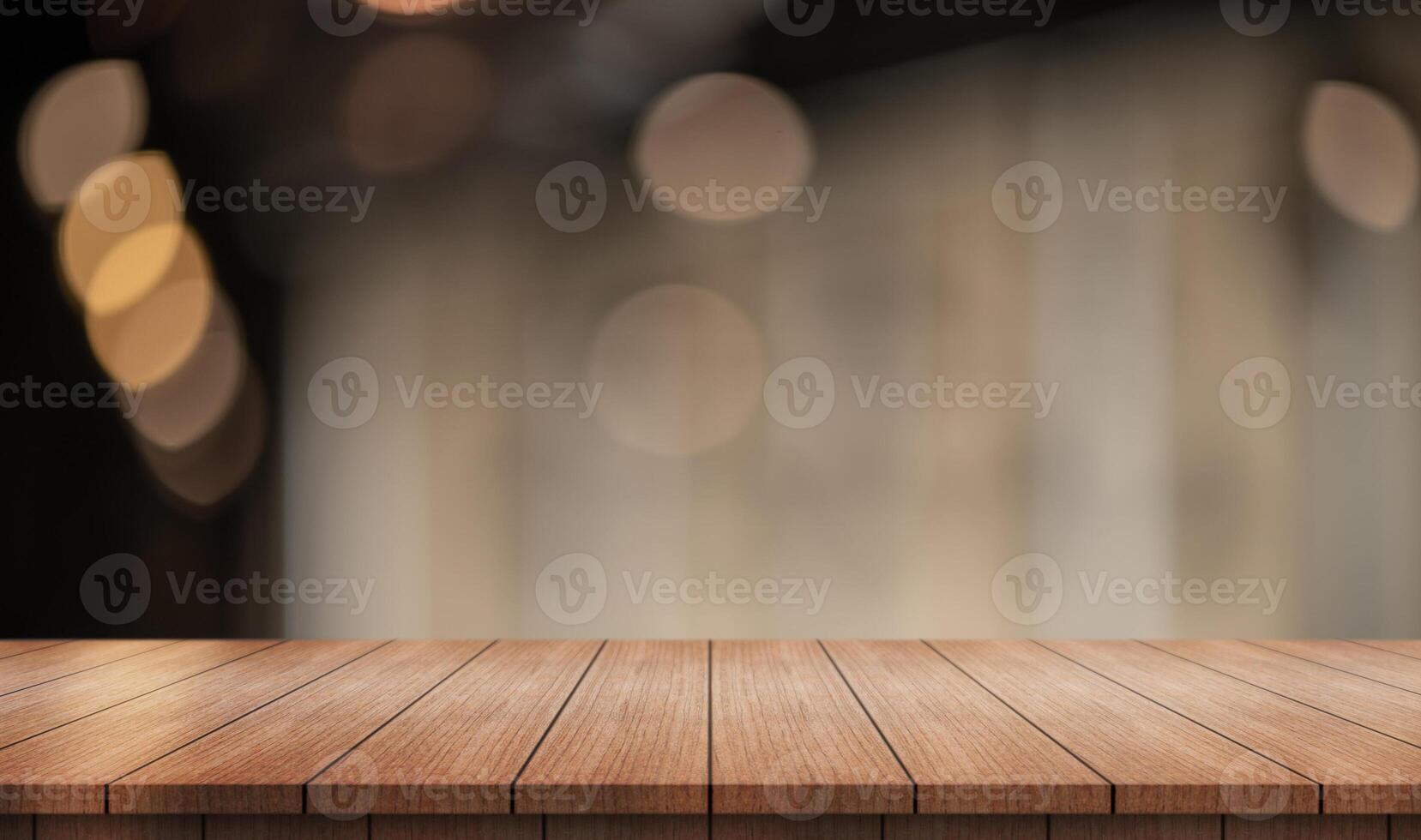 Empty wooden table top with lights bokeh on blur restaurant background. photo