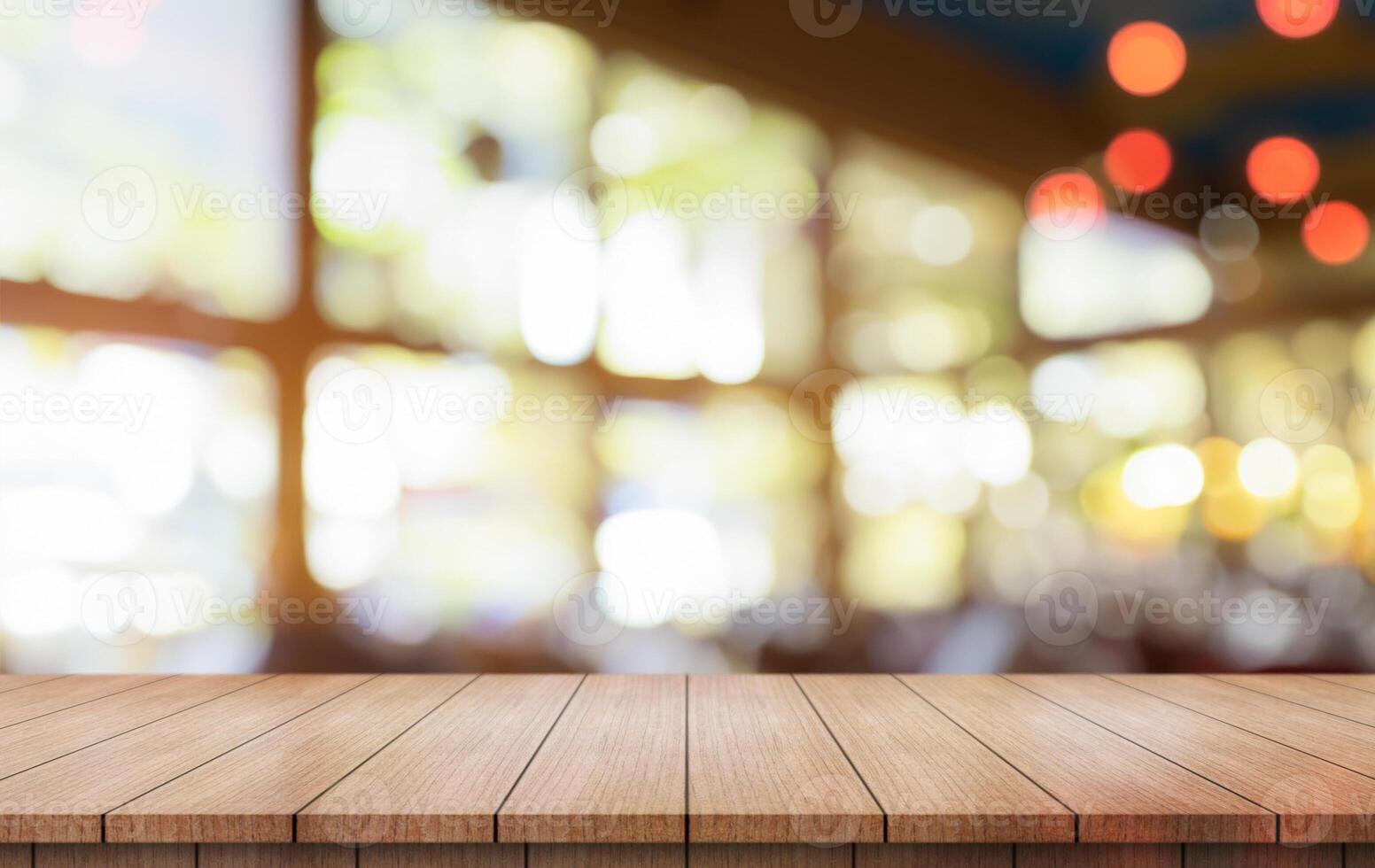 Empty wooden table top with lights bokeh on blur restaurant background. photo