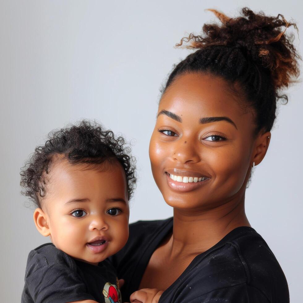 Portrait of a smiling young mother holding her baby photo