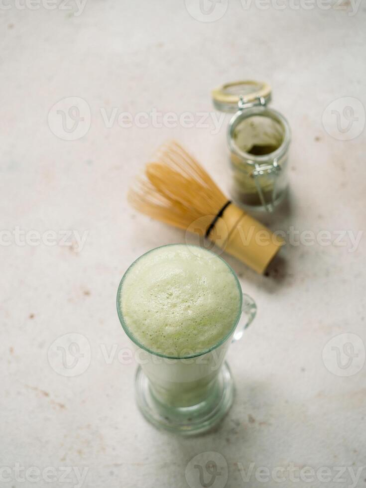 Green foam texture extreme close up as background. Perfect green matcha tea latte foam with bubbles macro shoot. Copy space for text. Vertical. photo