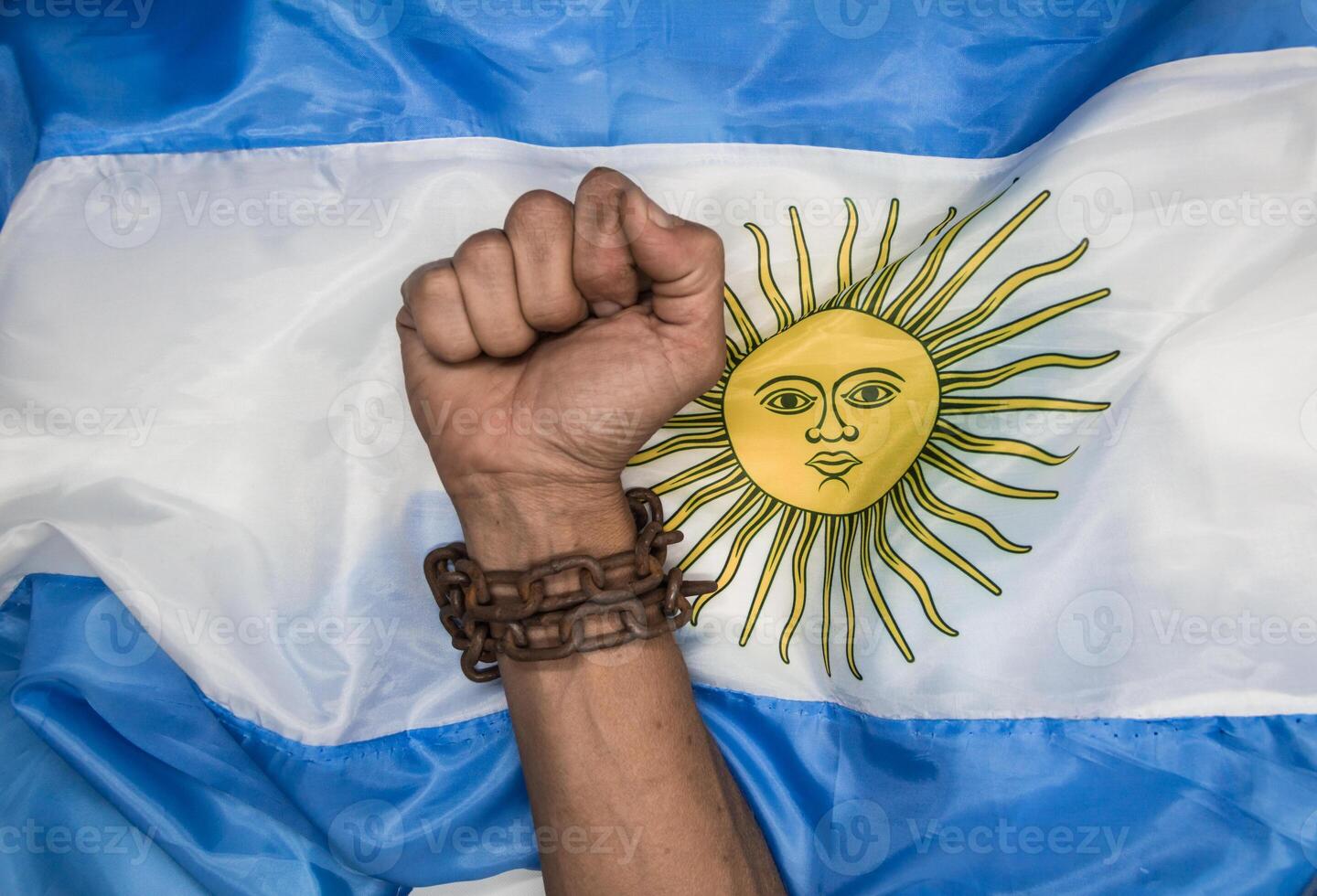 Fists that break the chains on the Argentine flag. Argentine revolution and independence concept photo