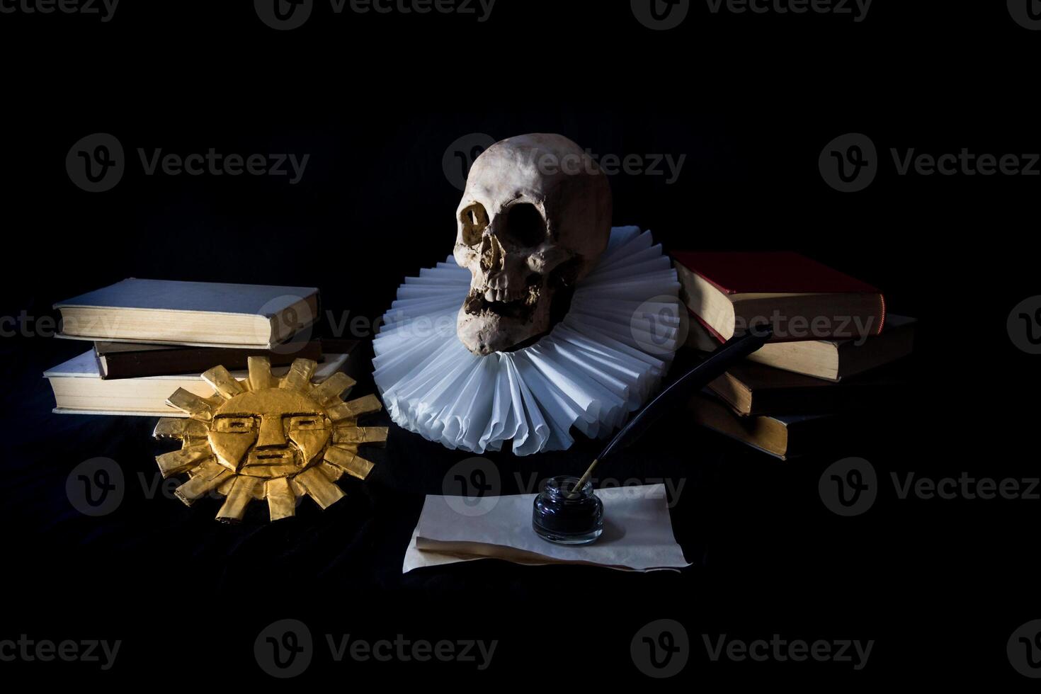 Books with a human skull, a ruff and the Inca sun, symbols of universal literature. Day of the book photo