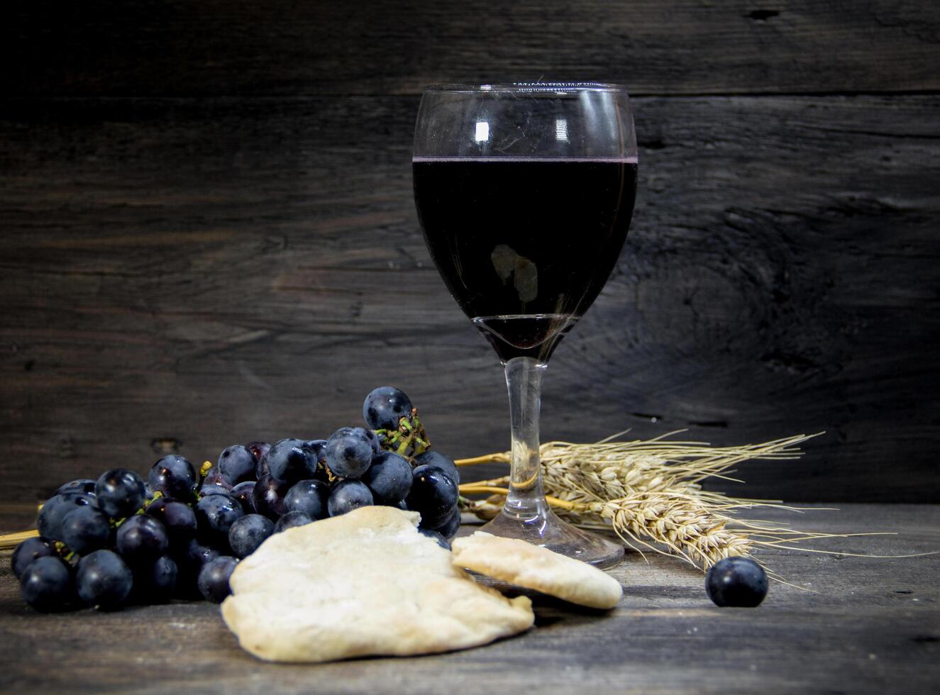 sour bread, wine, grapes and wheat symbol of Christian communion photo