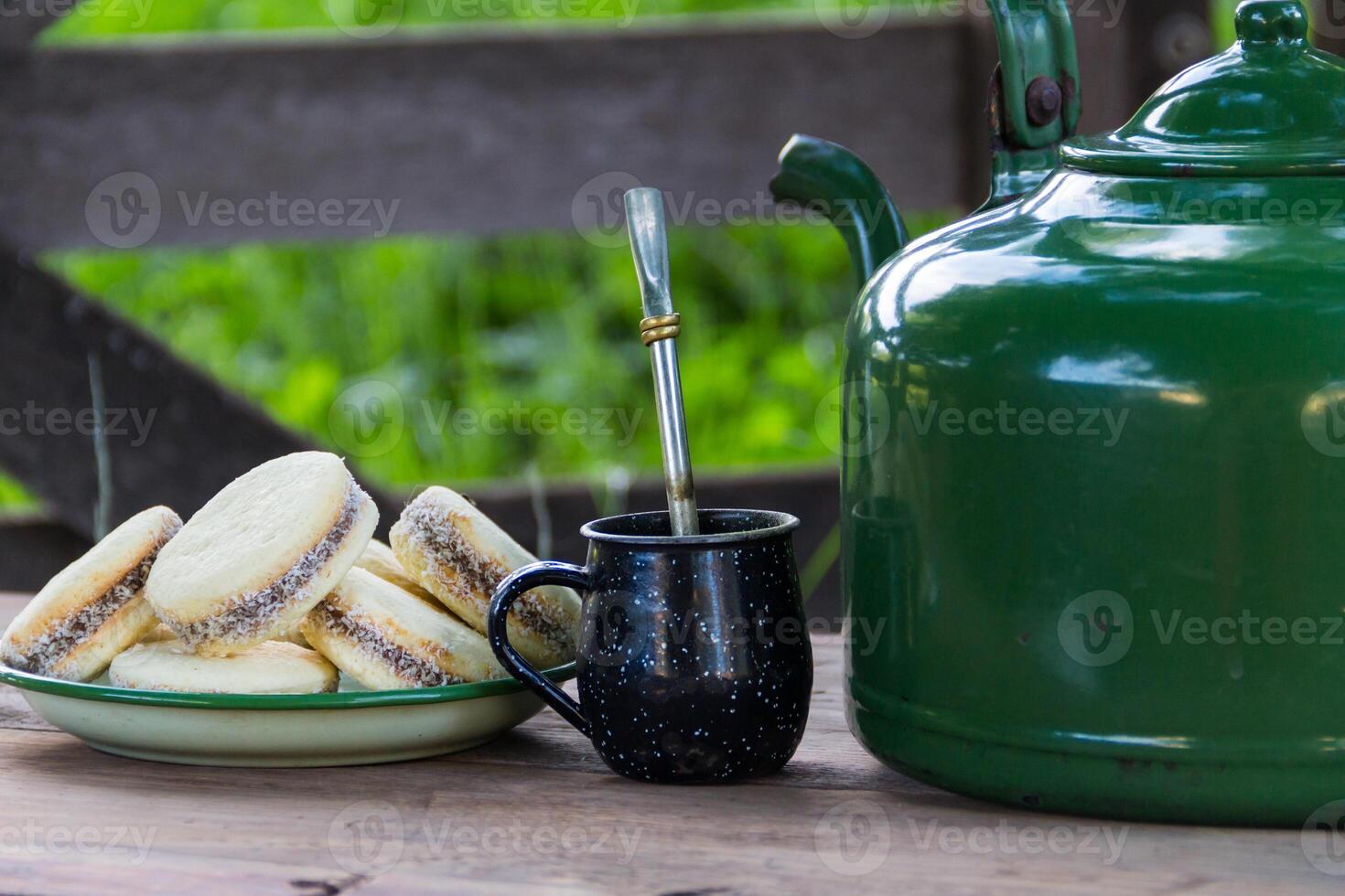 Mate and kettle with a plate of alfajores and yerba mate infusion in the Argentine countryside photo