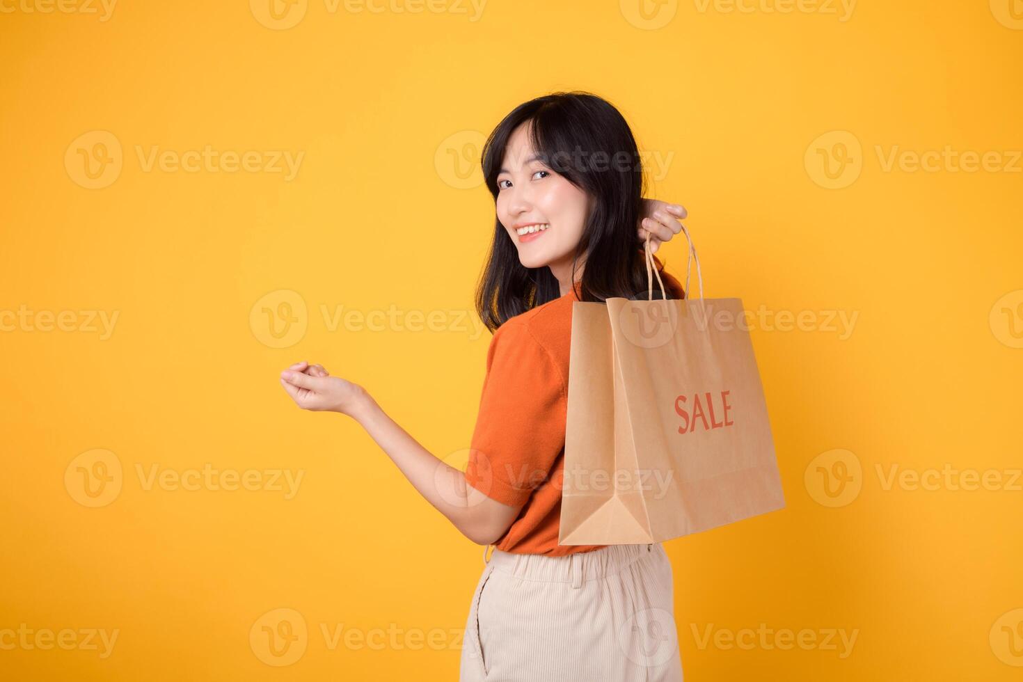 Step into a world of smiles, shopping, and style. Happy asian young woman holds bags, symbolizing the joy of purchasing trendy items at discounted prices. photo