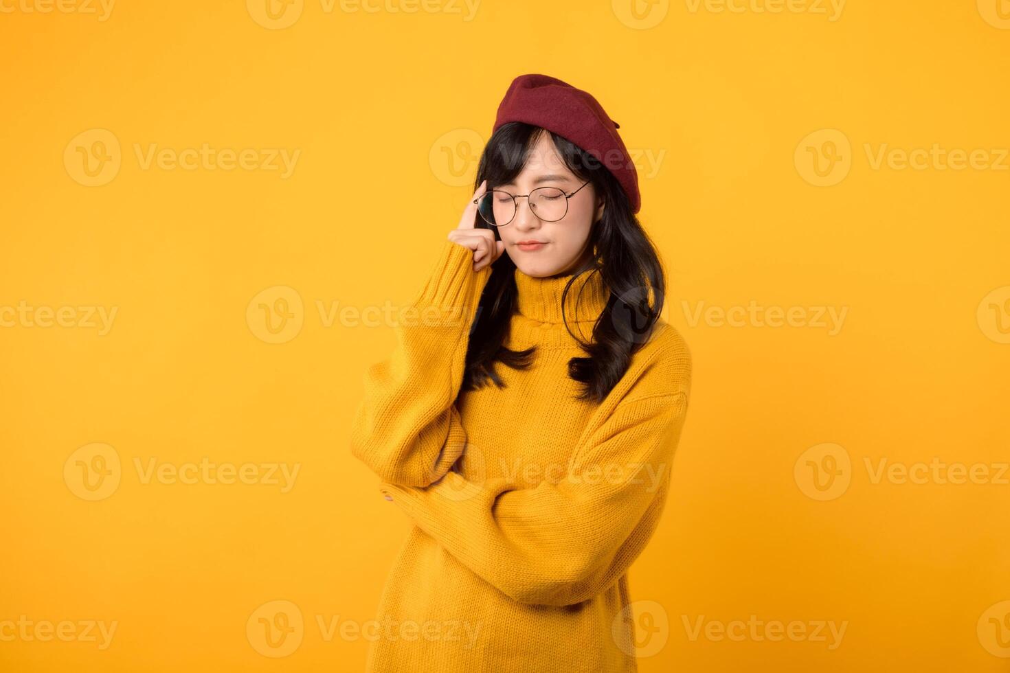 Lifestyle, people emotions and casual concept. Thoughtful stylish young asian woman wearing yellow shirt, dreaming or imaging perfect plan, have interesting idea, thinking against yellow background. photo