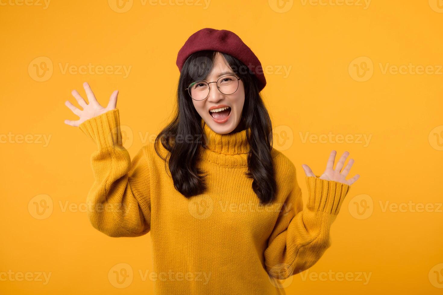 A stylish woman wearing a red beret and eyeglasses, expressing shock and wonder on a yellow background. photo