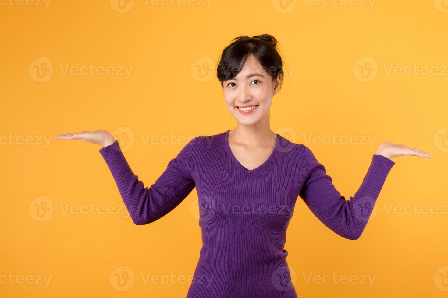 A happy and confident young woman with a cheerful smile, presenting a skincare product in an empty space. Beauty and satisfaction in one portrait. photo