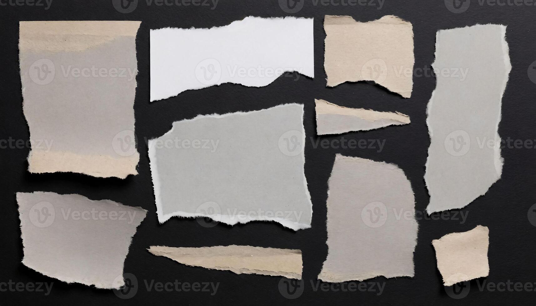 several pieces of torn paper on a black background photo