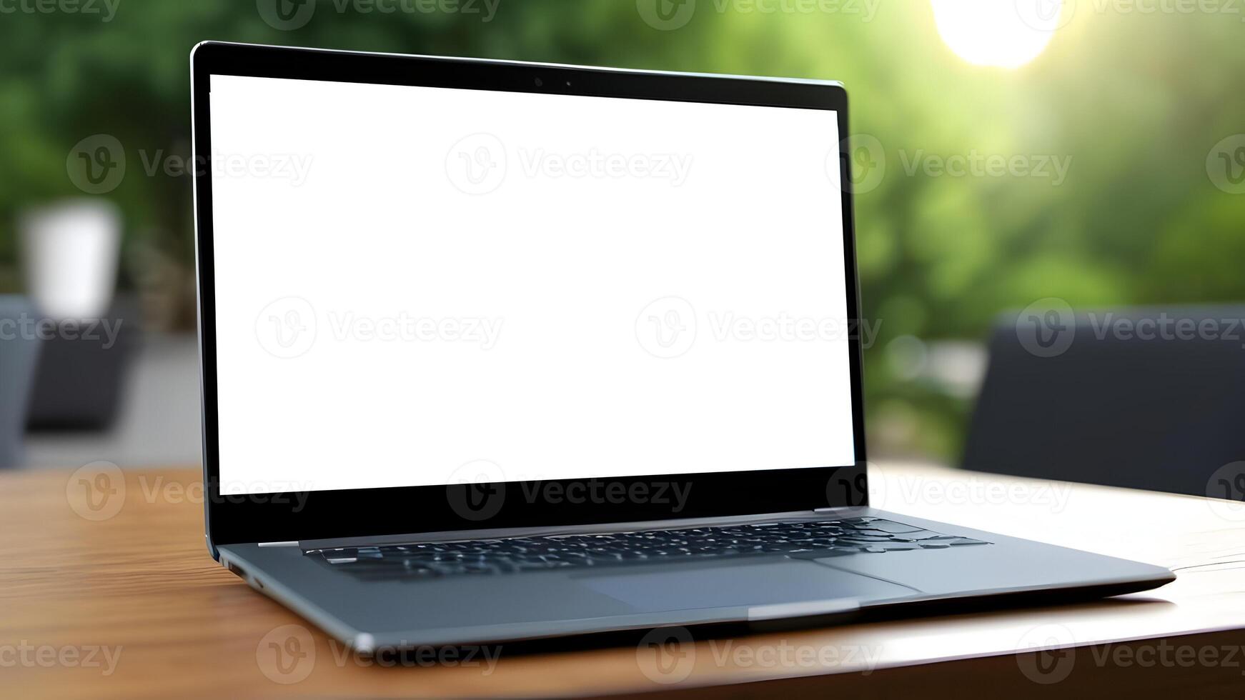 Laptop with white blank screen on wooden table with blurred background photo