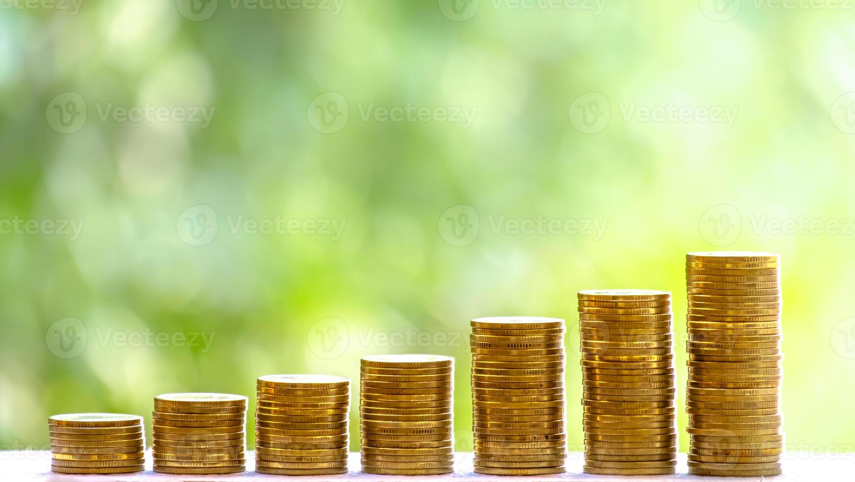 Business Finance and Money concept, Money coin stack growing graph with green tree bokeh background,investment concept photo