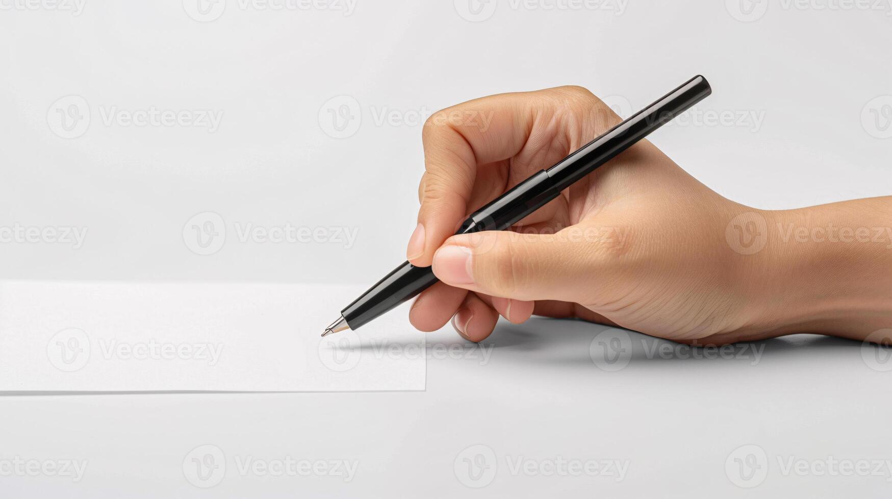 Hand holding pen and paper on white background photo