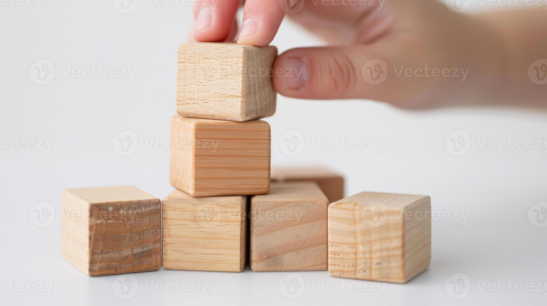 Hand putting and stacking blank wooden cubes on table with copy space can add text or icon photo