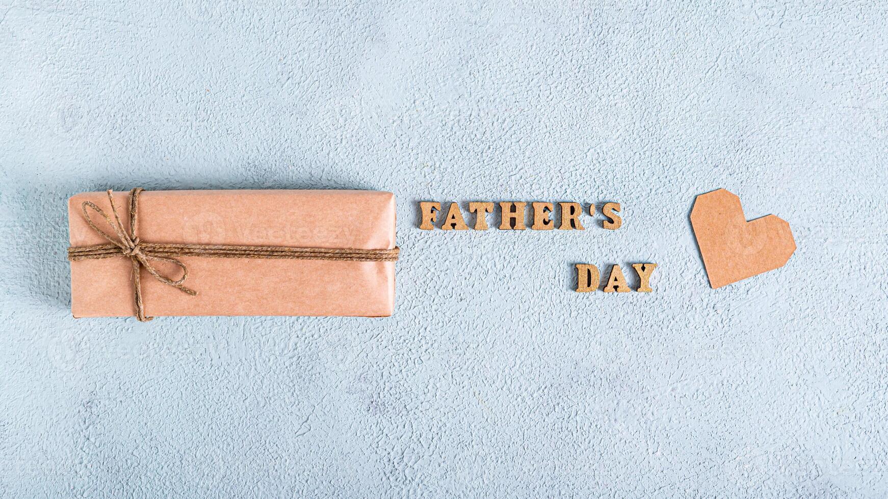Father's day craft gift, cardboard heart and inscription on a blue background web banner photo
