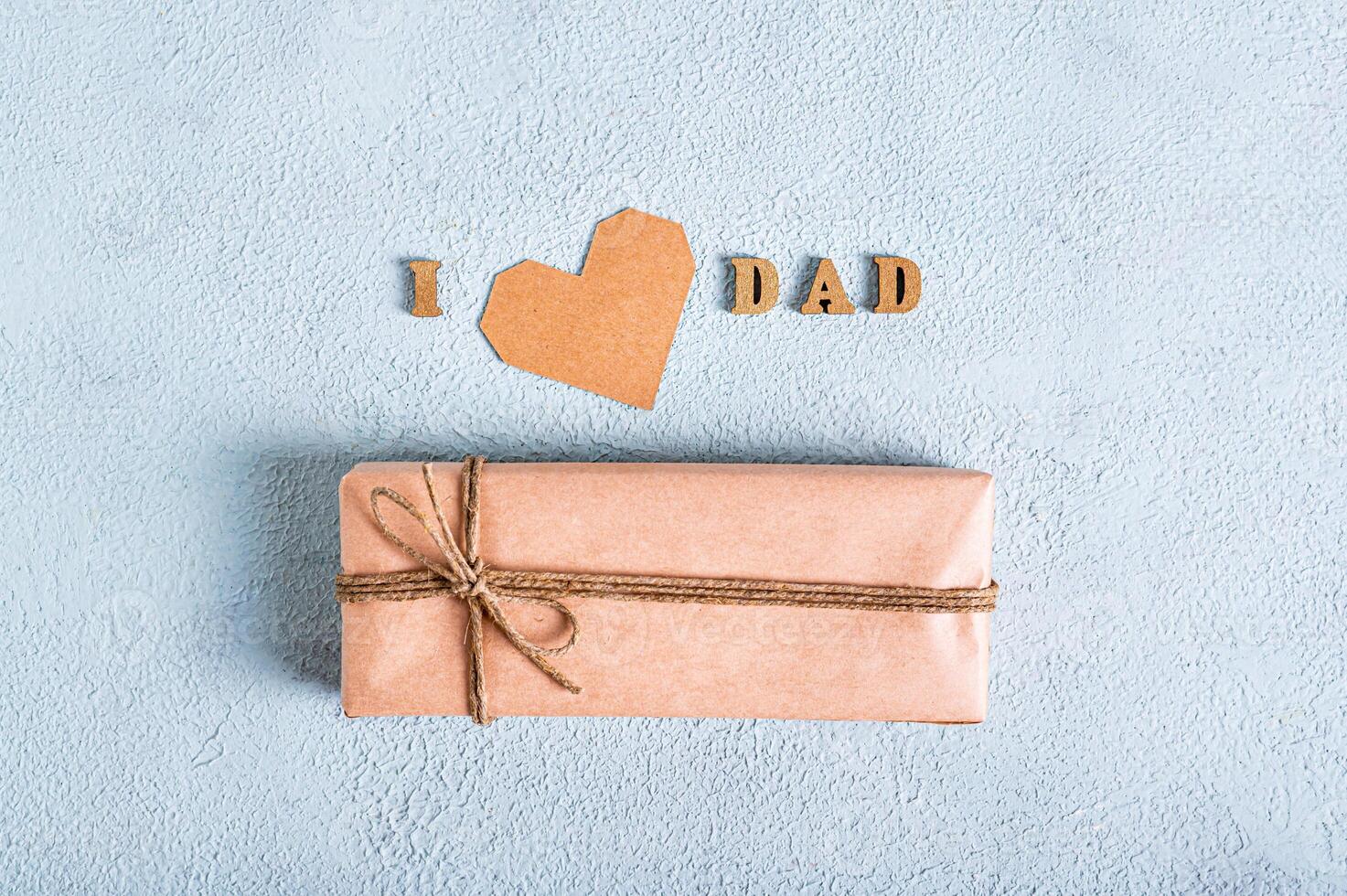 Father's day craft gift, cardboard heart and inscription on a blue background photo