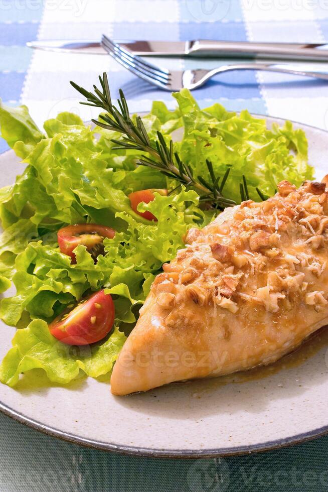 grilled chicken stuffed with sauce and salad photo