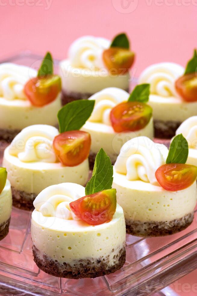 cream cheese and cherry tomato canape on tray photo