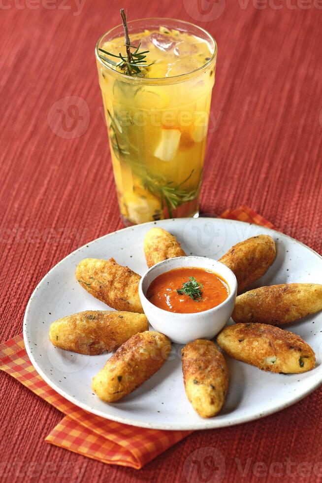 fruit caipirinha with cod fritters and red pepper photo