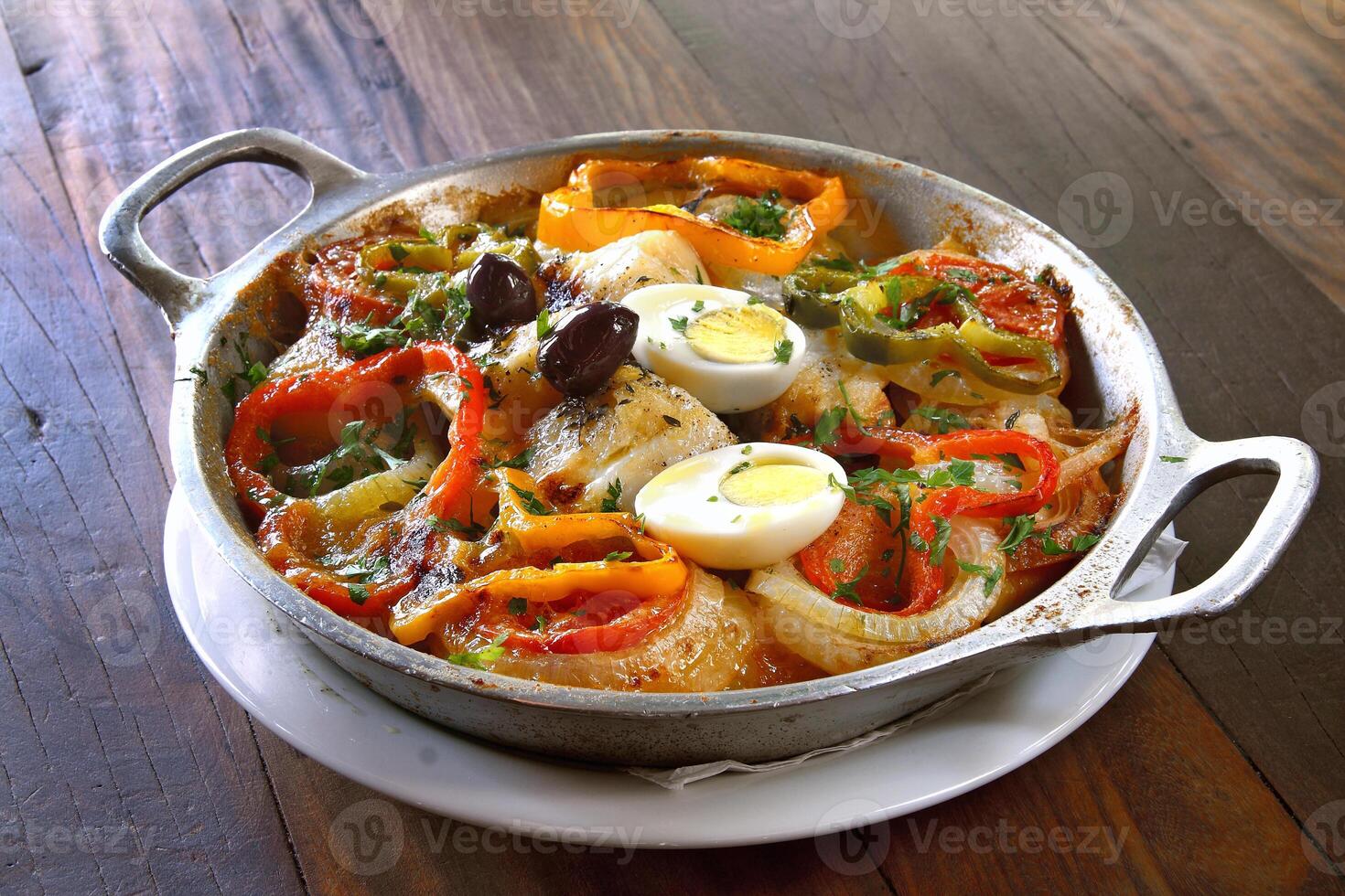 Wood-fired cod with eggs and peppers photo