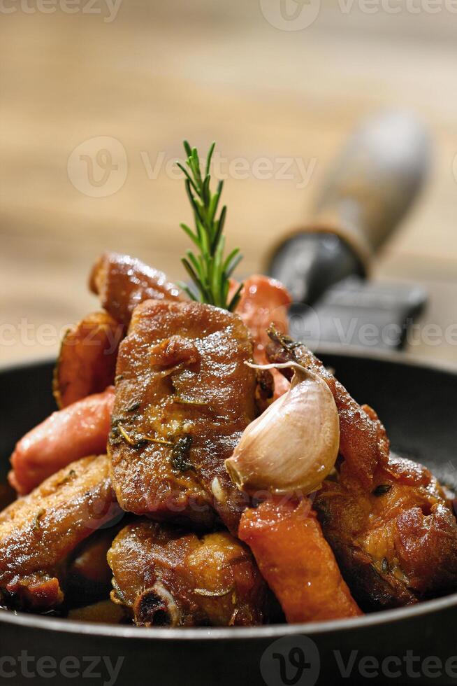 Porco na Lata, classic Brazilian dish of pork fried in a pan with garlic photo