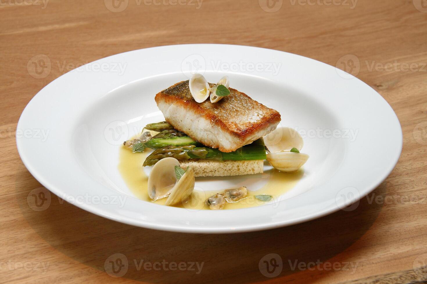 Cambucu hake with asparagus, bread and vongole photo
