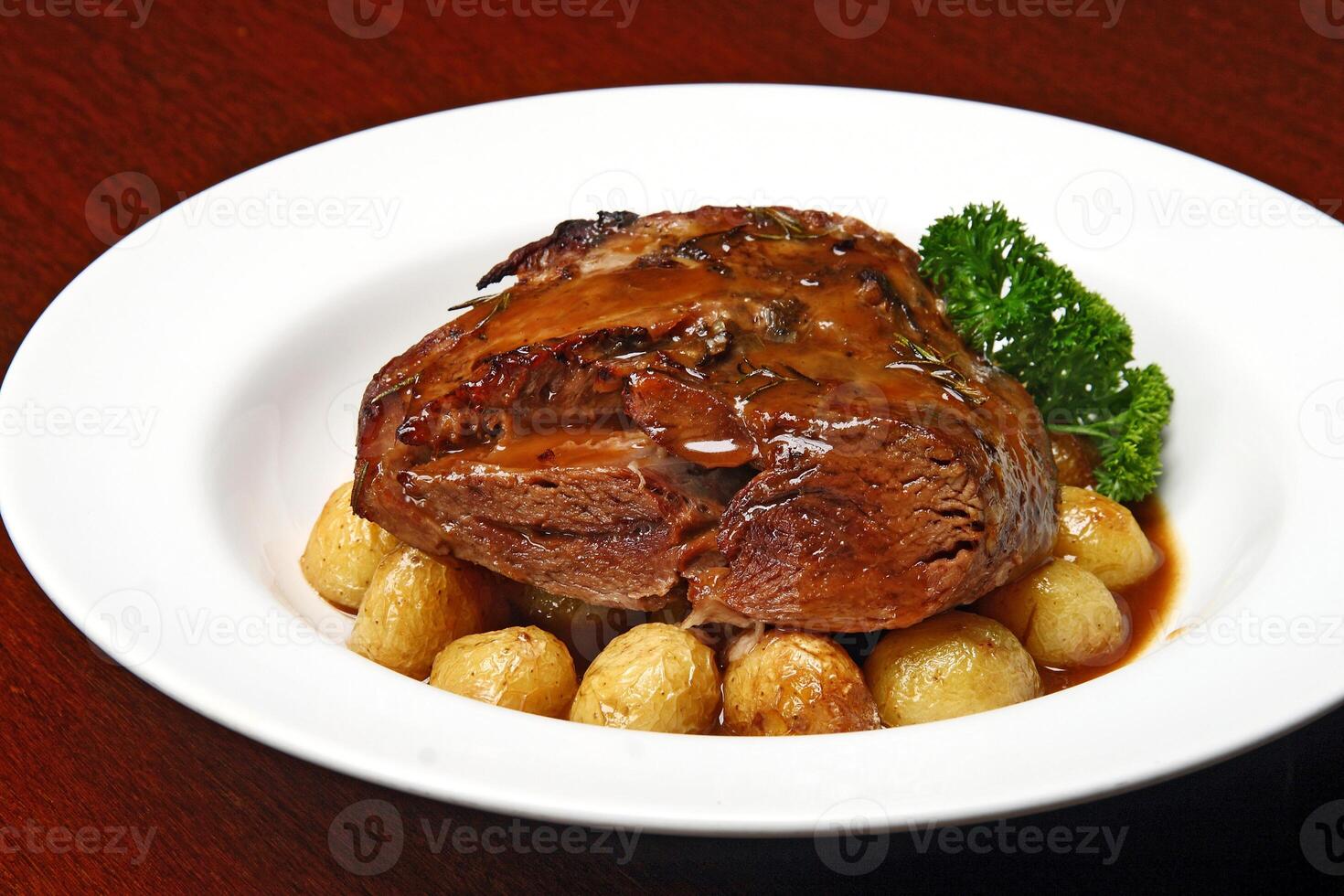 Lamb shoulder with baked potatoes and sauce photo