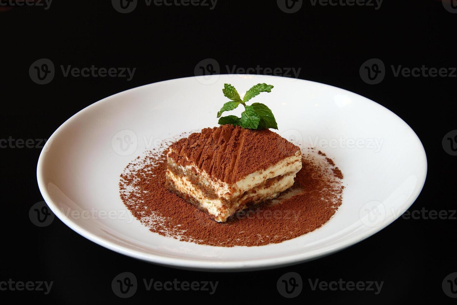 Tiramisu, classic Italian dessert covered in chocolate on top photo