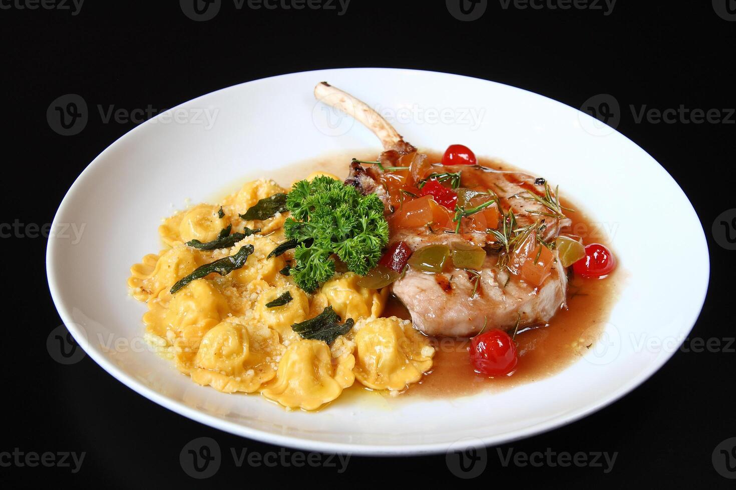 oven-baked pork rib with tomato sauce and pork ravioli photo