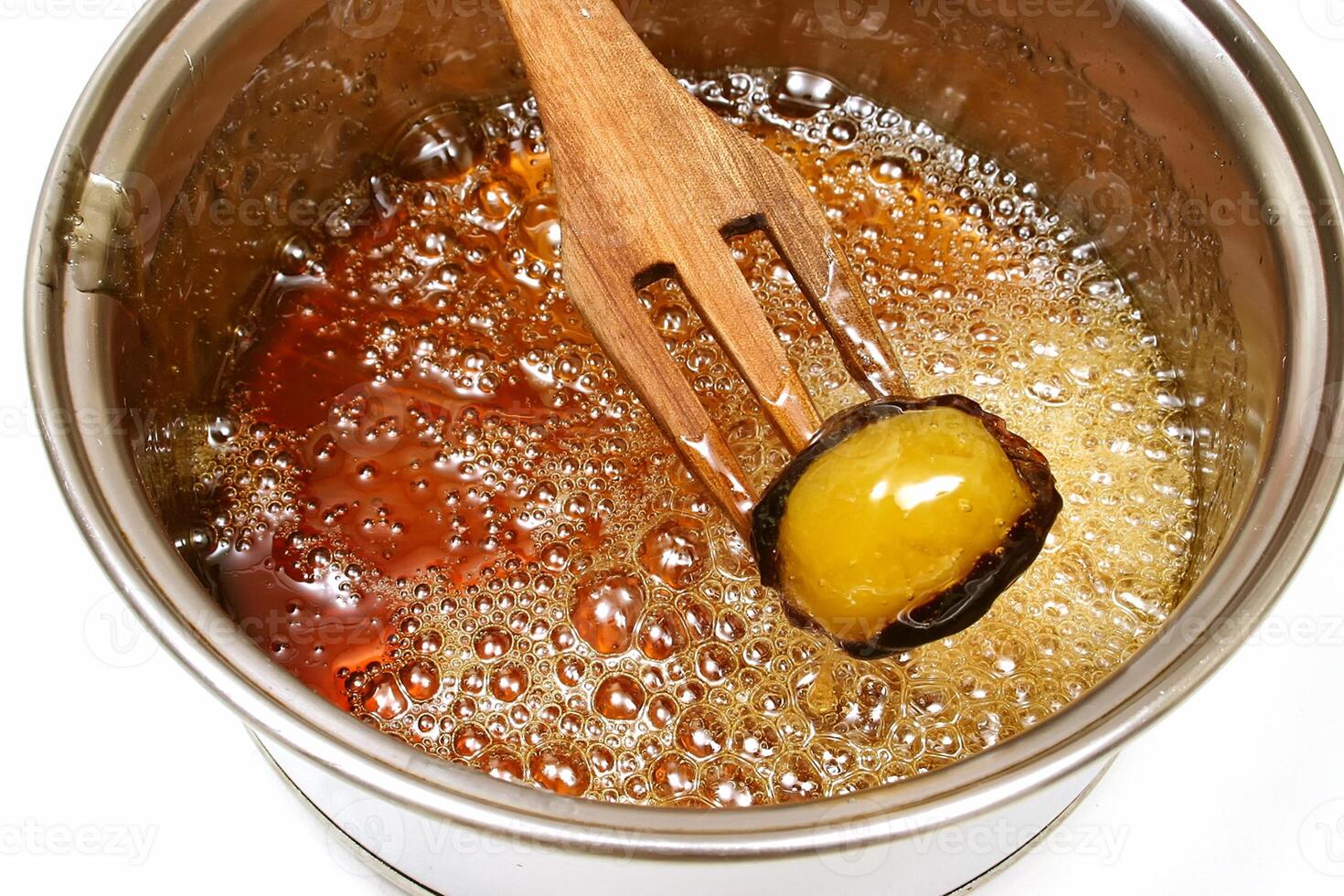 Brazilian sweet, mother-in-law's eye, being caramelized in the pan photo