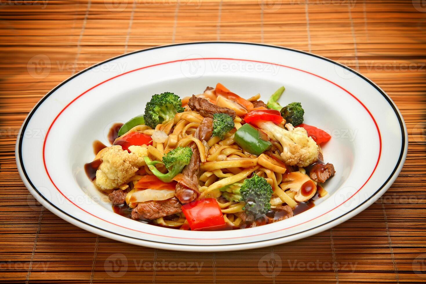 Classic yakisoba with meat, pasta and chopped vegetables photo