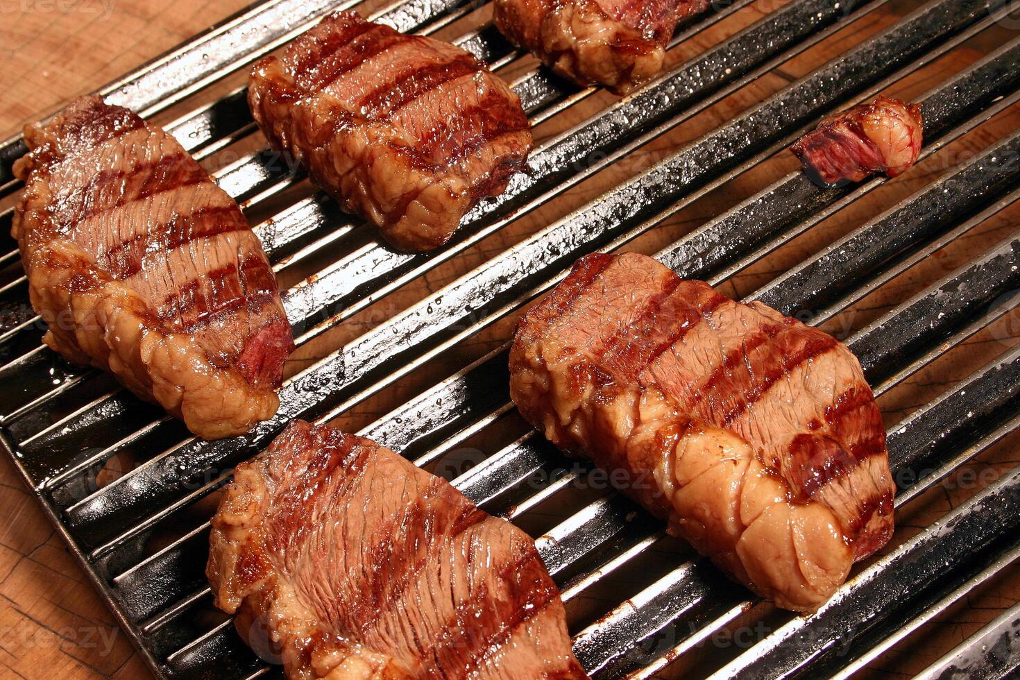 professional butcher teaching step by step how to prepare picanha, a Brazilian cut of meat photo