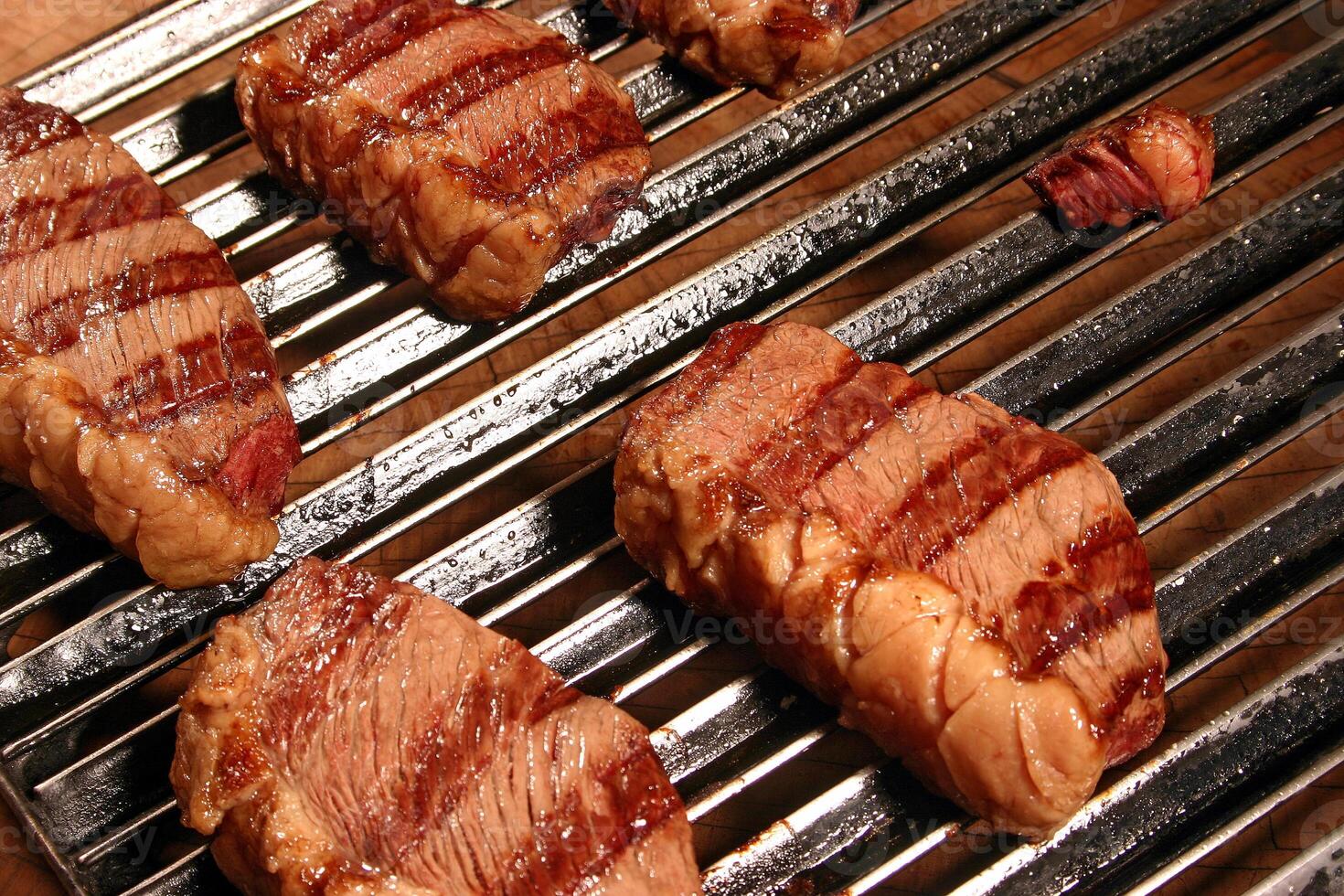 professional butcher teaching step by step how to prepare picanha, a Brazilian cut of meat photo