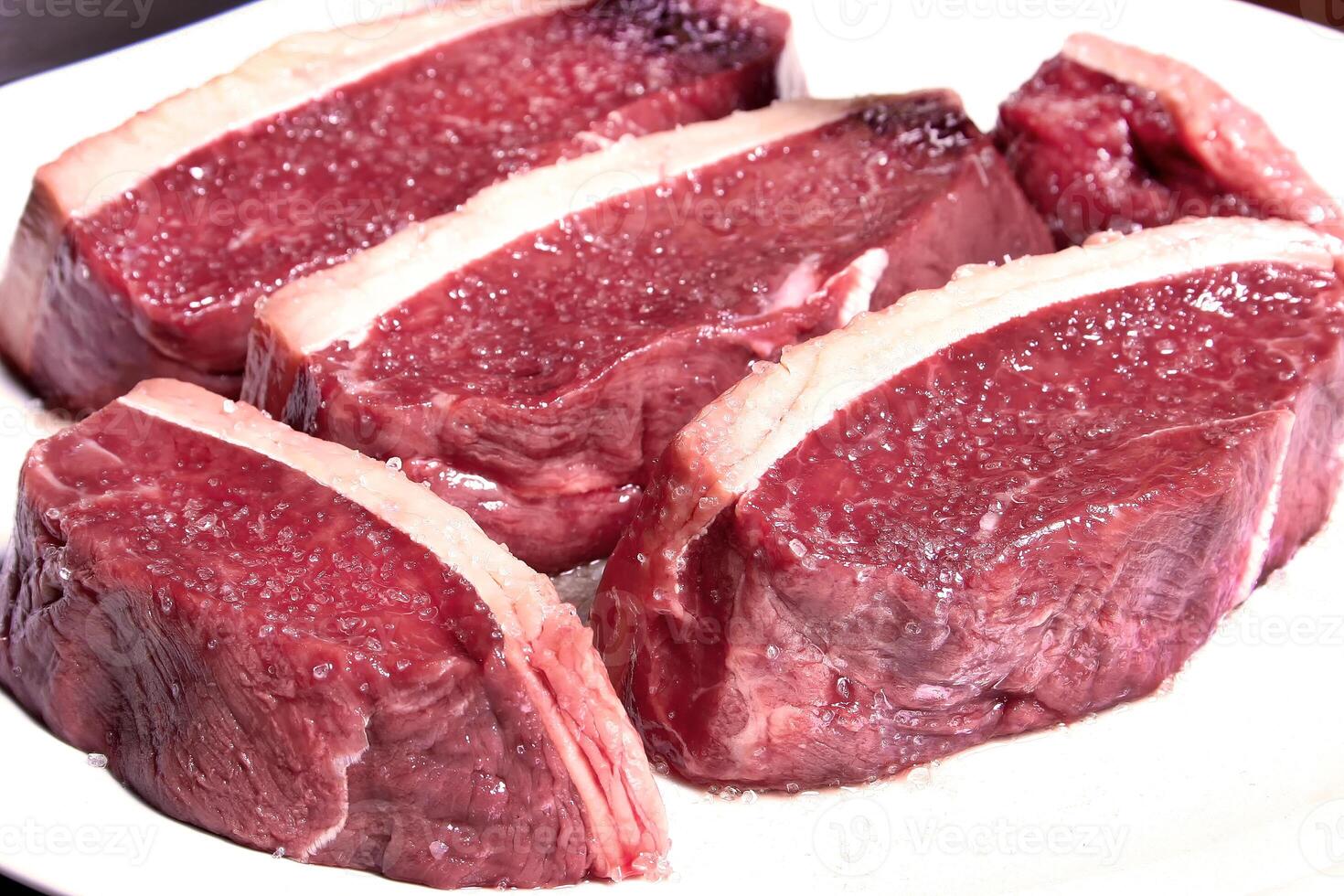 professional butcher teaching step by step how to prepare picanha, a Brazilian cut of meat photo