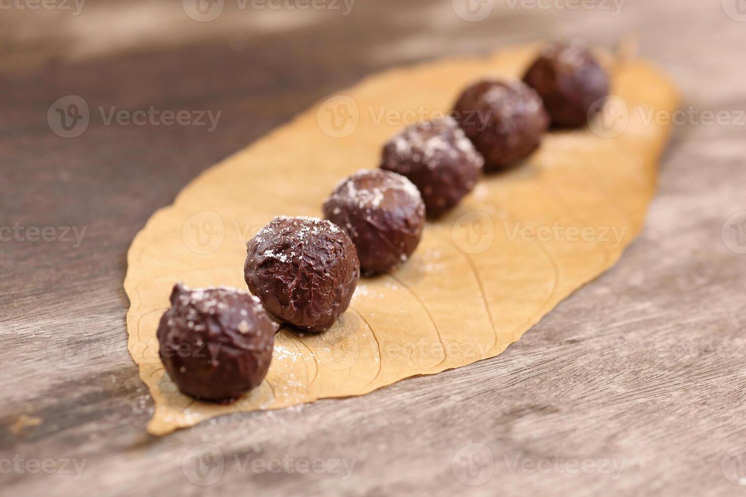 Chocolate truffles with 70 percent cocoa and nuts photo