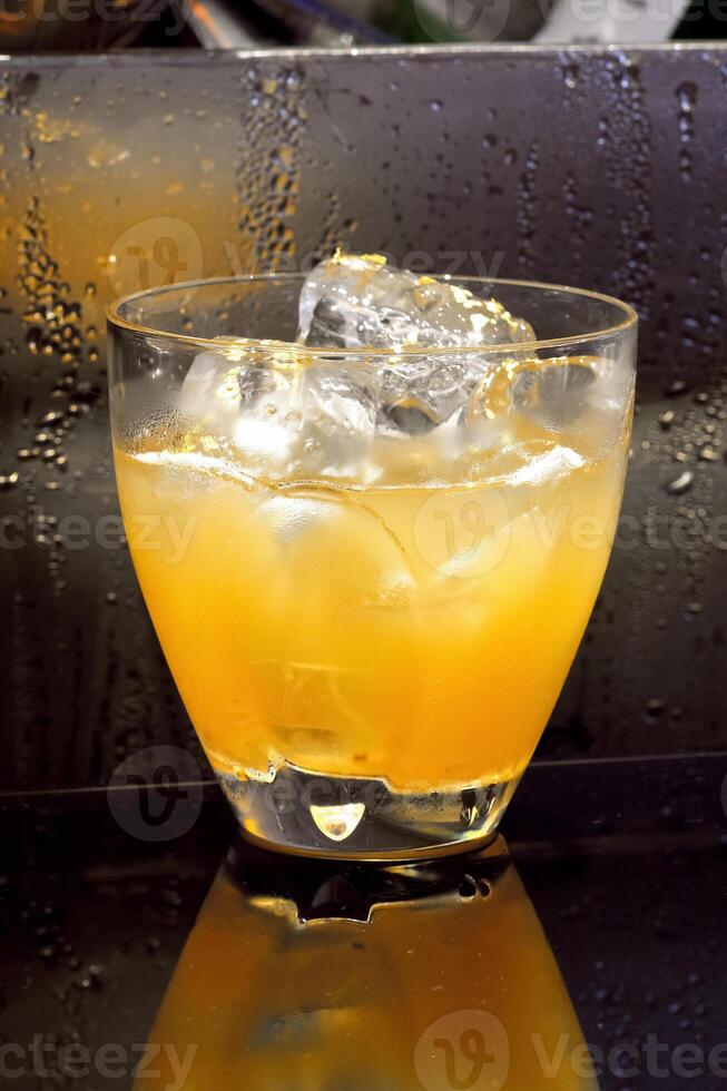 Cheetah, drink with gin, liqueur, peach tea, lemon and ice photo
