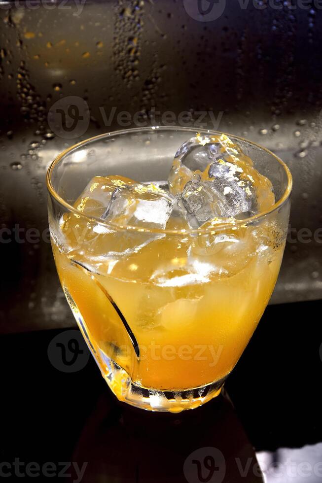 Cheetah, drink with gin, liqueur, peach tea, lemon and ice photo