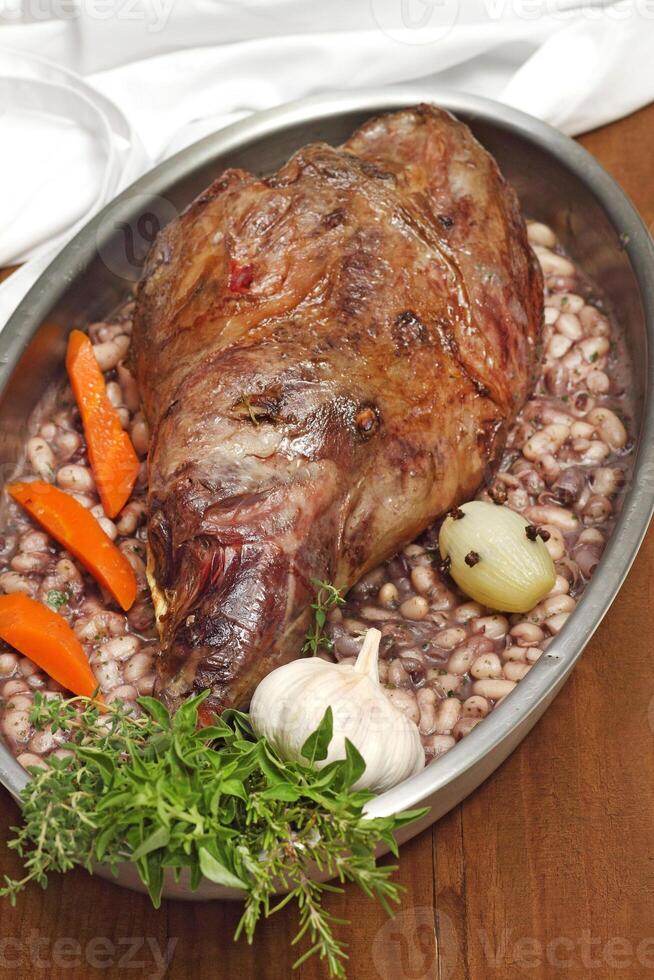 step by step guide to Gigot d'agneau, a classic dish of French cuisine, leg of lamb with pink garlic, rosemary, port wine and olive oil photo