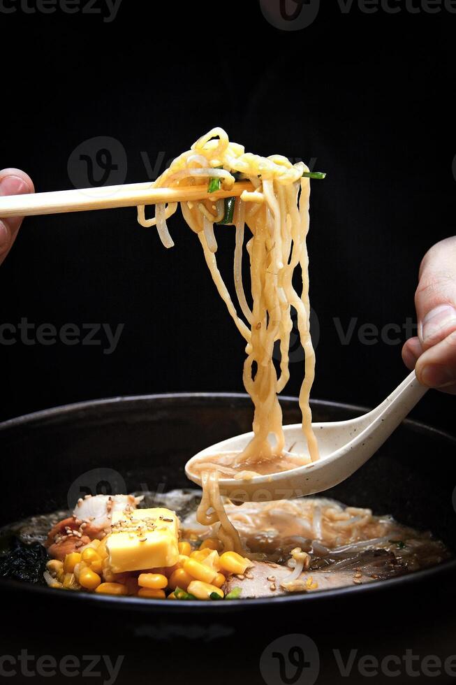 Japanese ramen, soup mix with noodles, meat, eggs and vegetables photo