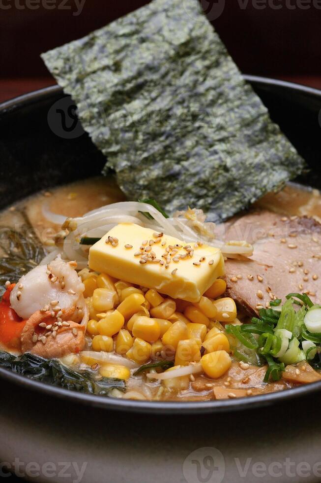 Japanese ramen, soup mix with noodles, meat, eggs and vegetables photo