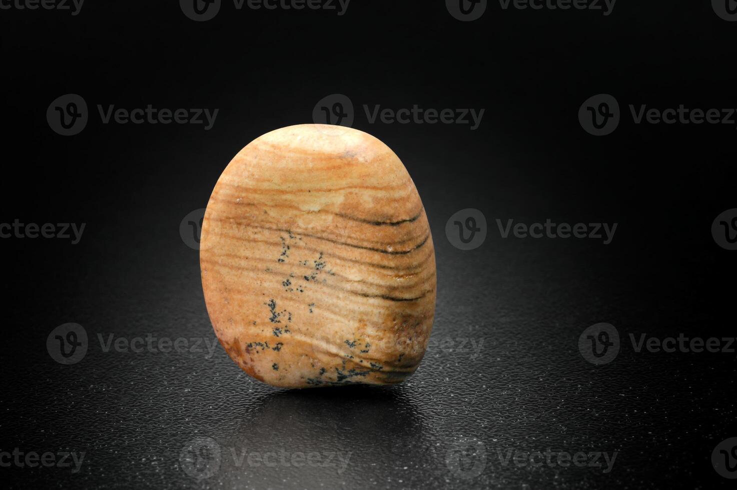 Jasper, Brazilian gemstone on dark background photo