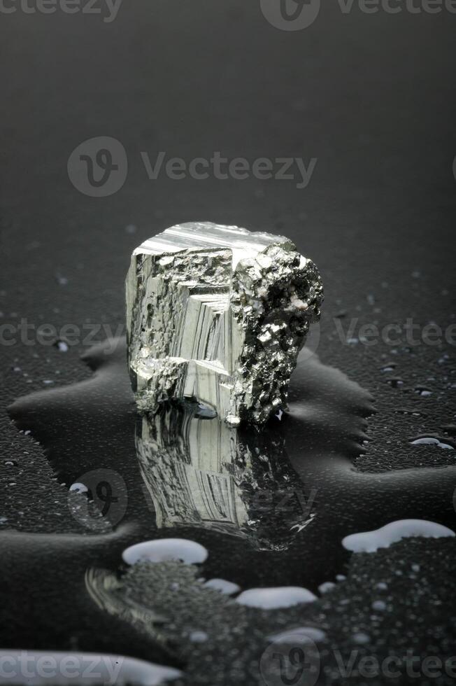 Pyrite, Brazilian gemstone on dark background photo