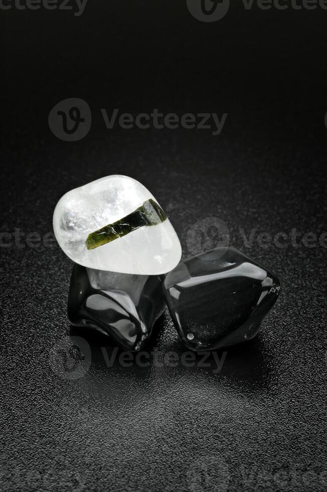 white quartz and green tourmaline, Brazilian gemstone on dark background photo