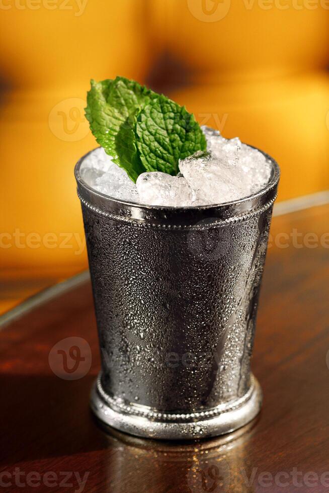 Mint Julep, classic drink with mint, bourbon whiskey, sugar syrup and aromatic bitters photo