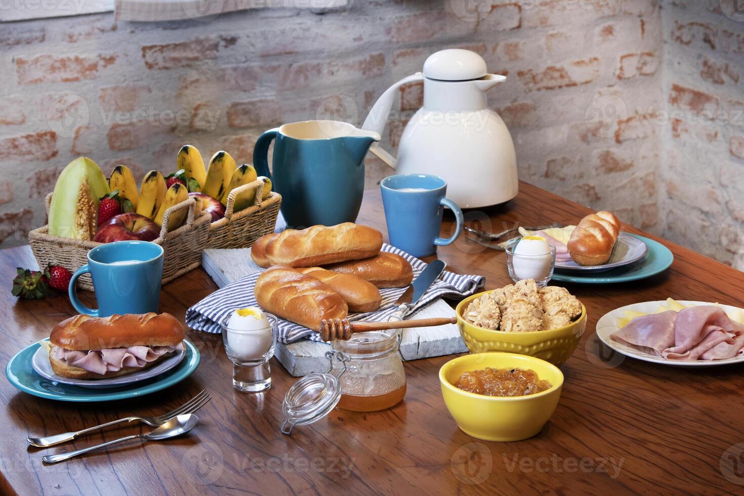 breakfast with ham, cheese, eggs and bread on the table photo