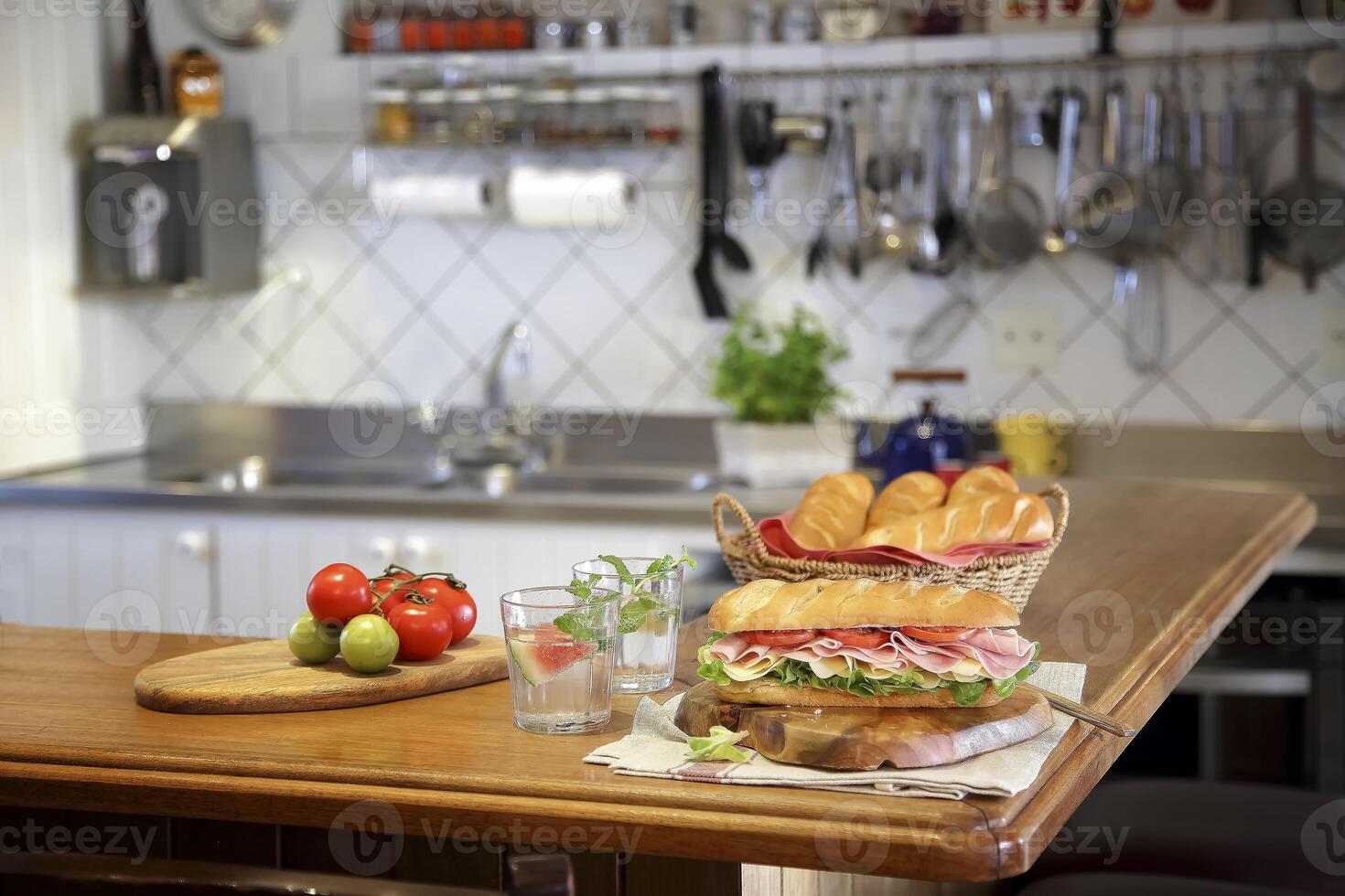 large sandwich of ham, cheese and tomatoes on the kitchen table photo