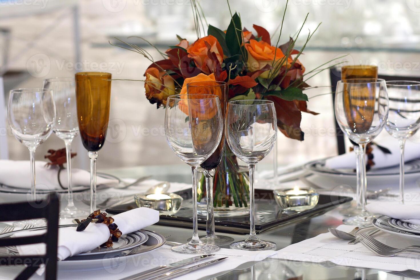 sophisticated tables with plates, cutlery and fine glasses close-up photo